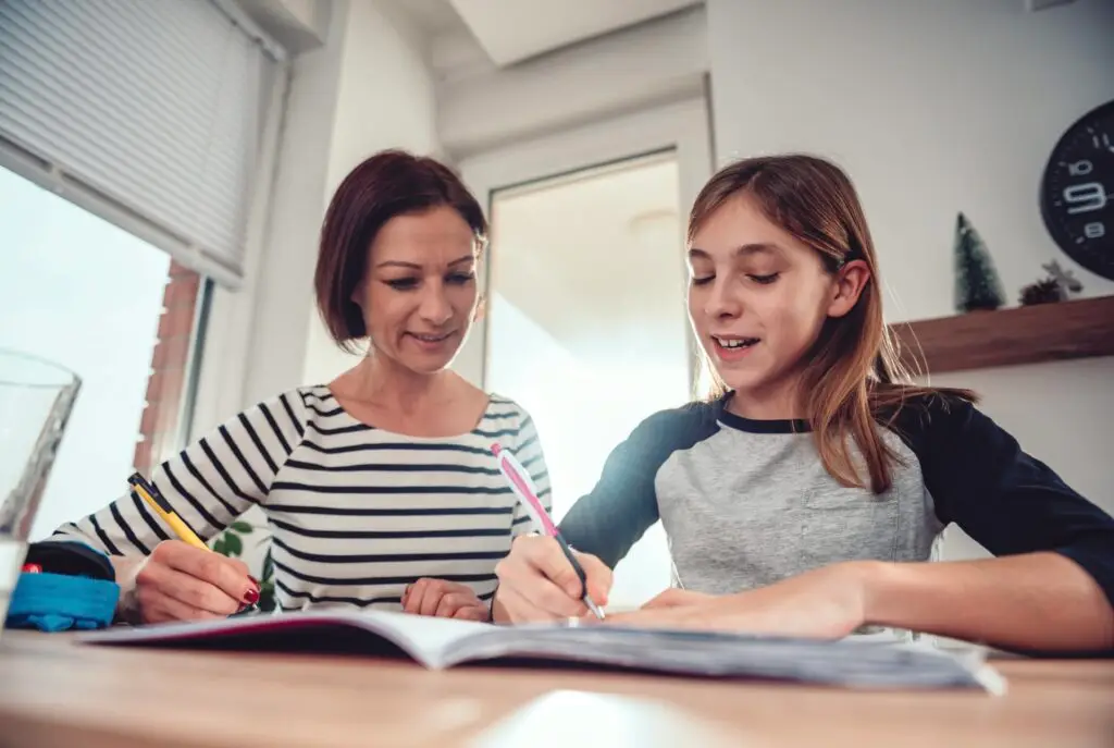 A mother working on homework with her child.